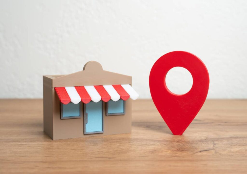 Shop and red geolocation sign